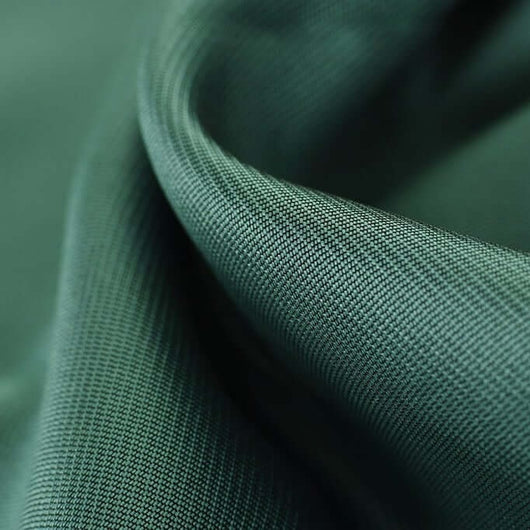 Close-up of green fabric with a textured pattern